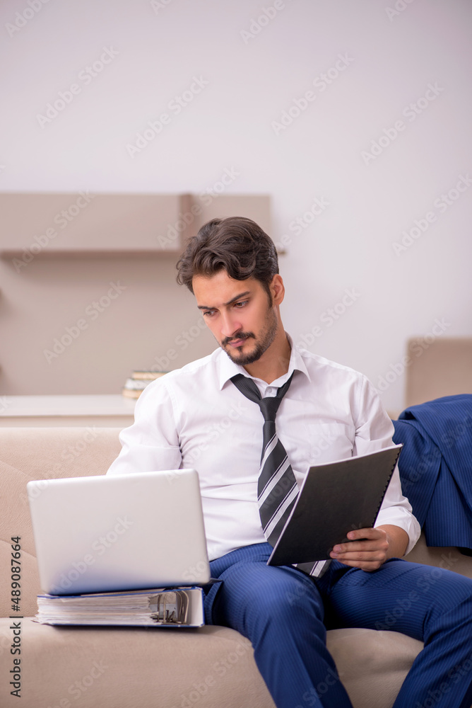 Young male employee working from home during pandemic Young male employee working from home during pandemic