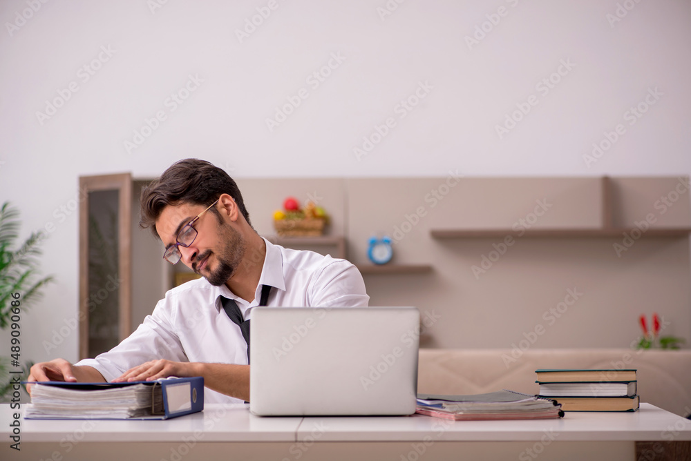 Young male employee working from home during pandemic Young male employee working from home during pandemic
