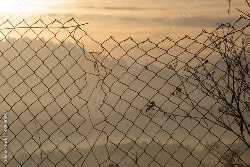 Sunny broken metal fence