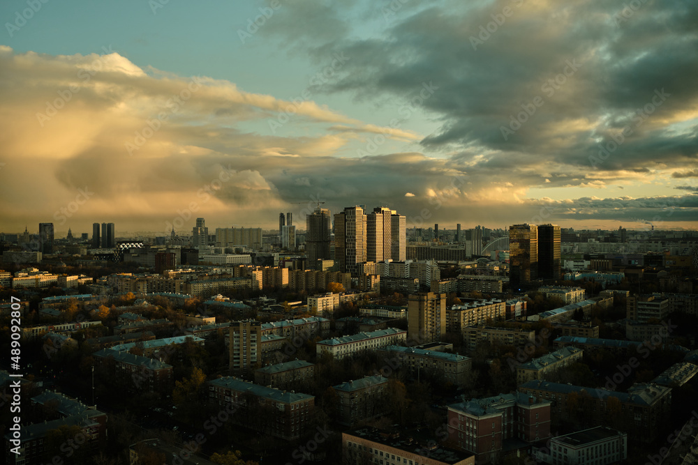 Evening panorama of Moscow, setting sun is reflected in office buildings. Cityscape and beautiful sky