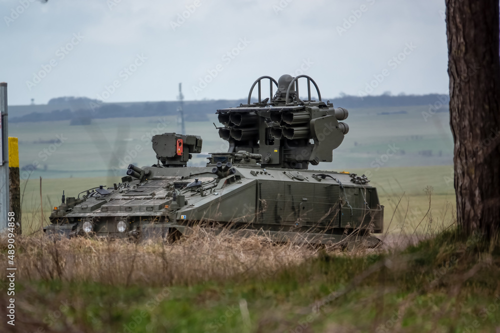 Fototapeta premium British Army Alvis Stormer Starstreak CVR-T tracked armoured vehicle equipped with short range air defense high-velocity missile system in action on a military exercise, Wiltshire UK
