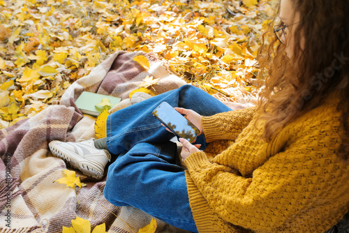 Young woman sitting on plai...