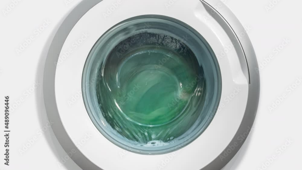Timelapse white domestic washing machine, laundry machine wash colored clothes time-lapse shot. Washing clothes. Motion blur round drum, spinning circle on white background. Zoom out Timelapse white domestic washing machine, laundry machine wash colored clothes time-lapse shot. Washing clothes. Motion blur round drum, spinning circle on white background. Zoom out