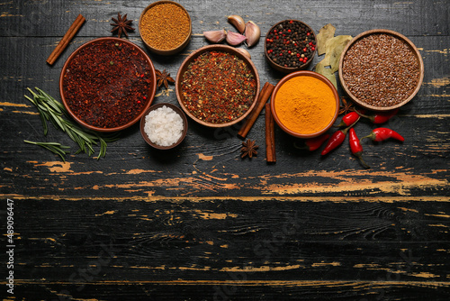 Fototapeta Naklejka Na Ścianę i Meble -  Set of aromatic spices on dark wooden background