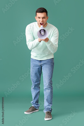 Angry young man shouting in...