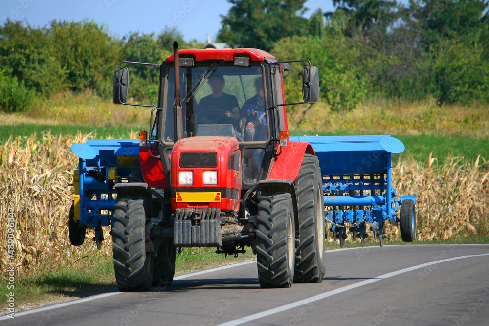 Tractor with seeder in the field Tractor with seeder in the field