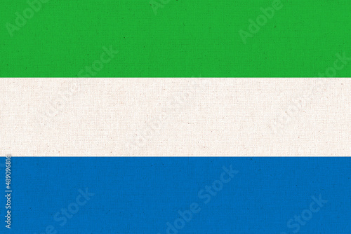Sierra Leone national flag on patterned background. Fabric Texture
