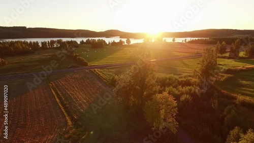 Beautiful sunset over lake and fields