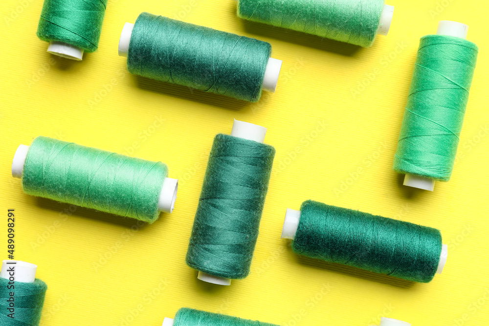 Different sewing threads on yellow background Different sewing threads on yellow background