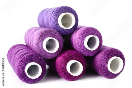 Purple sewing threads on white background