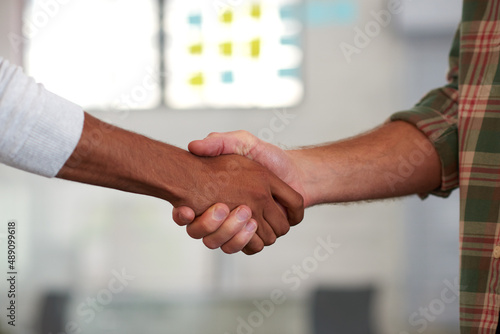 Its great to finally meet you. Two casual men shaking hands.