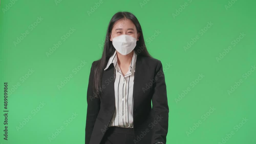 An Asian Business Woman Wearing Mask Walking In Front Of Green Screen In The Studio
An Asian Business Woman Wearing Mask Walking In Front Of Green Screen In The Studio