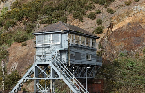 The trains control room at the City of Waterford Ireland train station set against the background of a rocky hill.