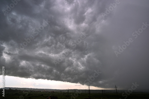 Landscape of dark ominous clouds forming on stormy sky during heavy thunderstorm