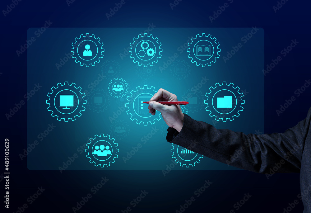 Fototapeta premium Control and management of business processes in the enterprise for efficient operation and increased profits. Concept with manager's hand and gears on holographic screen