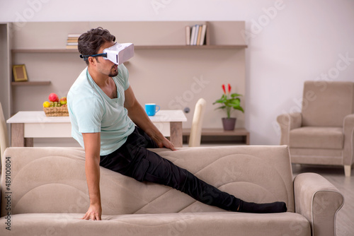 Young man student wearing virtual glasses at home © Elnur