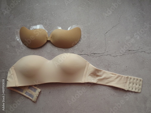 strapless bra on a concrete gray background close-up. High quality photo