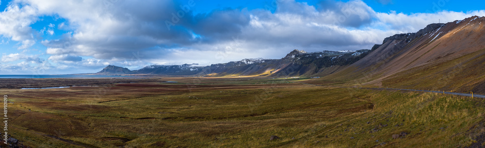 View during auto trip in Iceland. Spectacular Icelandic landscape with  scenic nature: mountains, ocean coast, fjords, fields, clouds, glaciers, waterfalls..