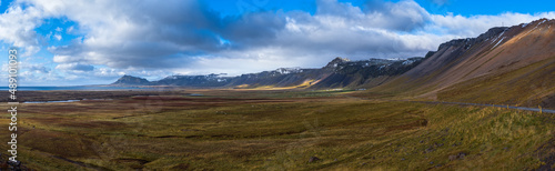 View during auto trip in Iceland. Spectacular Icelandic landscape with scenic nature: mountains, ocean coast, fjords, fields, clouds, glaciers, waterfalls..