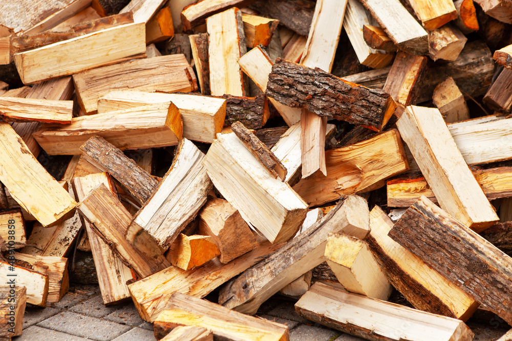 Stock of firewood for heating the house. The trees were cut down and split into firewood to be used as heating fuel in fireplaces and stoves, firewood background. Stock of firewood for heating the house. The trees were cut down and split into firewood to be used as heating fuel in fireplaces and stoves, firewood background.