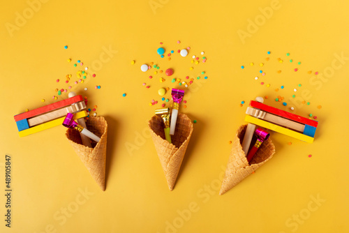carnival, party and Purim celebration concept (jewish carnival holiday) over yellow background photo