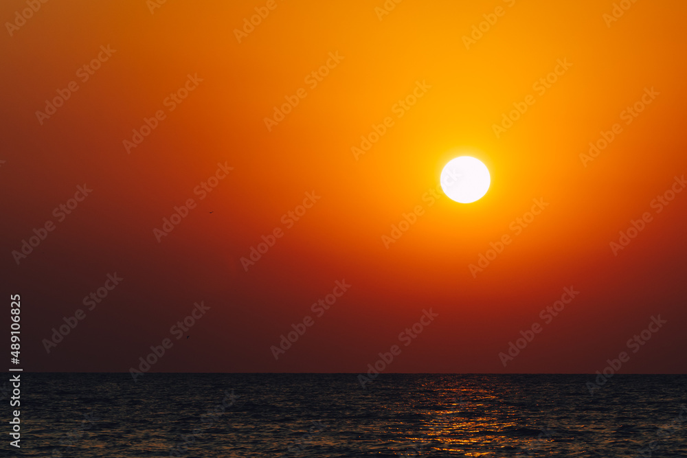 Dramatic vibrant sun over ocean