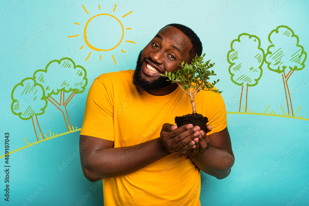 © alphaspirit - Man holds and takes care of a small tree