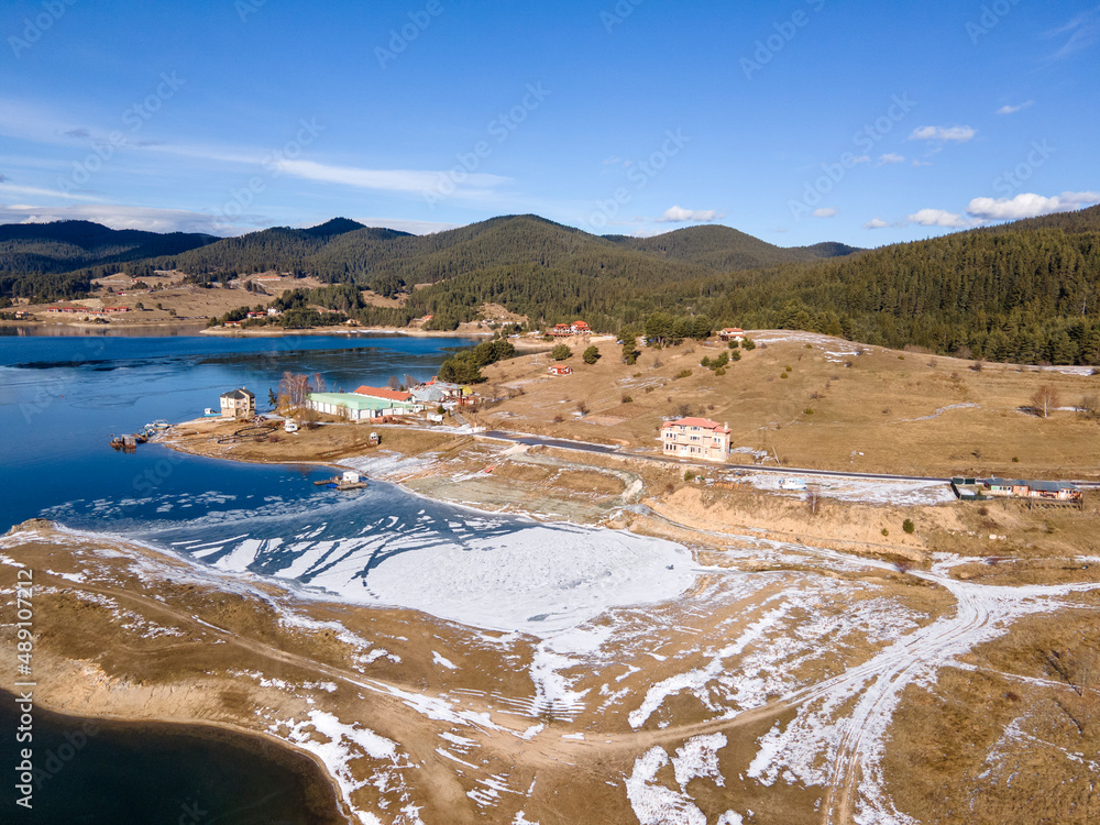 Aerial winter view of Dospat Reservoir covered with ice, Bulgaria
