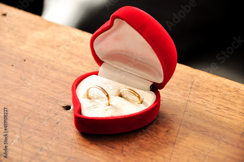 Wedding rings in a red heart shaped box