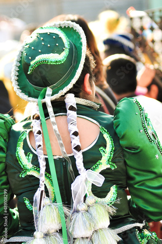 Girl with traditional costume and a green hat