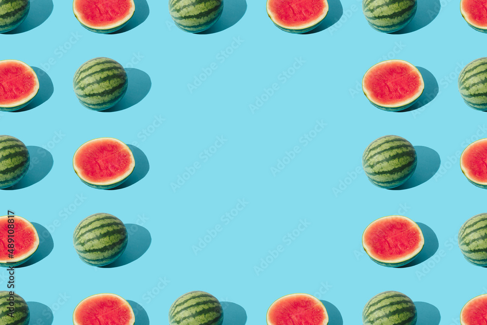 Arranged watermelon and the half on a blue pastel background. Minimal pattern and design. Copy space. Arranged watermelon and the half on a blue pastel background. Minimal pattern and design. Copy space.