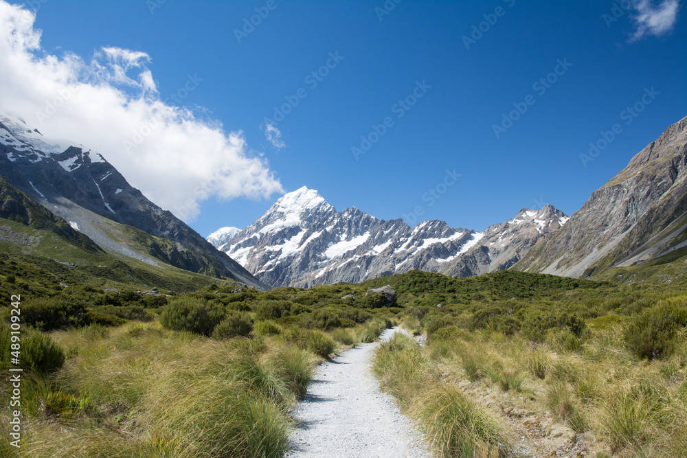 Gravel pathway through the valley surrounded by mountains, Mount Cook National Park, New Zealand