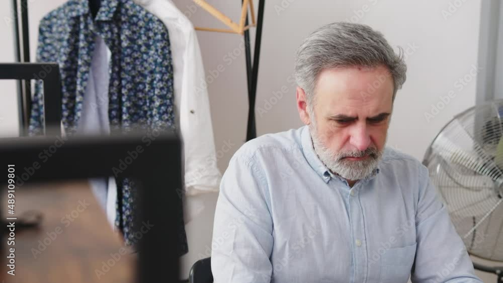 Middle age caucasian boss working on the computer in his home office. High quality 4k footage Middle age caucasian boss working on the computer in his home office. High quality 4k footage