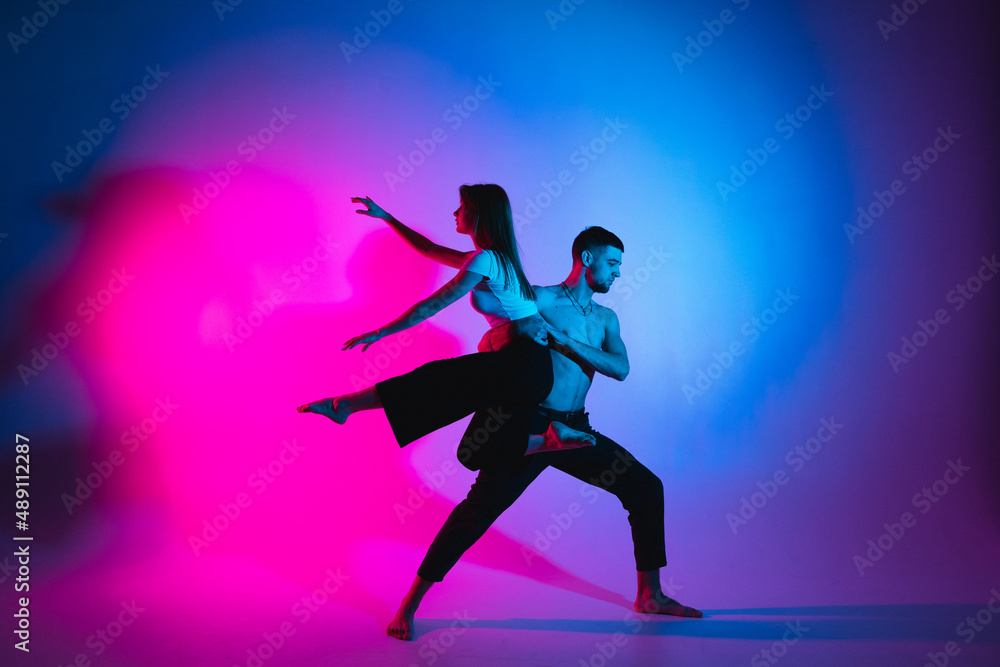 Gymnastics support. A man and a girl perform an acrobatic exercise