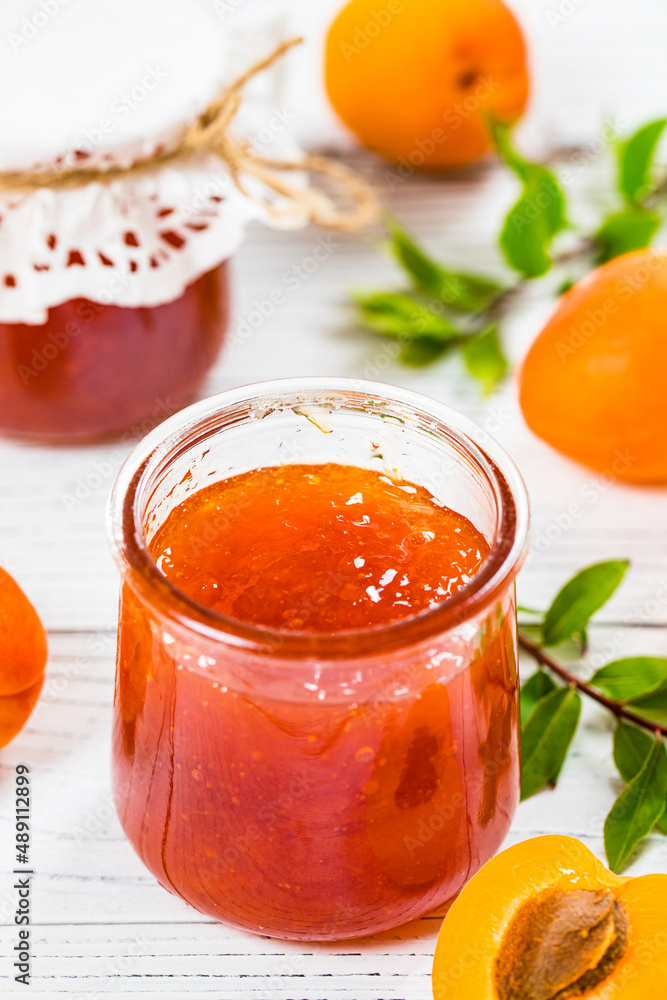 Apricot Jam with Fresh Summer Apricot on White Wooden Background. Selective focus. Apricot Jam with Fresh Summer Apricot on White Wooden Background. Selective focus.