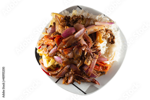 Lomo saltado with beef and Italian tripe with white rice, julienned onions, tomatoes and golden French fries on a white background photo