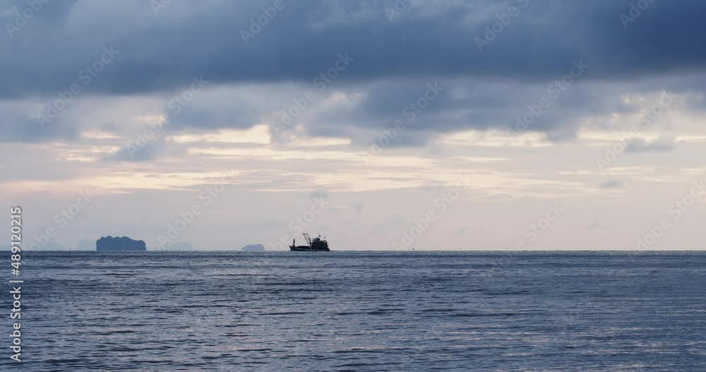 Cargo ship is sailing on the surface of the sea. Under the blue sky and clouds in the evening . Phuket , Thailand. Cargo ship is sailing on the surface of the sea. Under the blue sky and clouds in the evening . Phuket , Thailand.