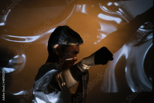 Light painting portrait, light drawing on projector beam exposure. Interesting and fantastic shooting in the studio