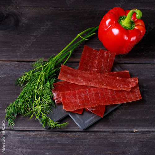 Beer with snacks on dark wooden table. Top view