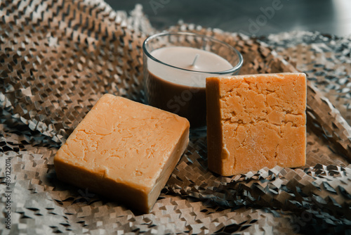 Candles burning in the dark against decorated on wood and Natural made soap