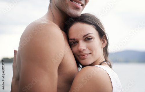 He stole my heart. Portrait of an intimate young couple enjoying a warm embrace by the waters edge.