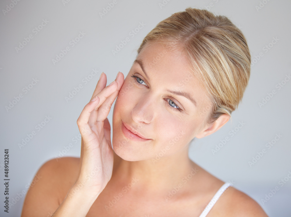 Goodbye wrinkles, hello flawless skin. Cropped shot of a beautiful woman touching her face. Goodbye wrinkles, hello flawless skin. Cropped shot of a beautiful woman touching her face.