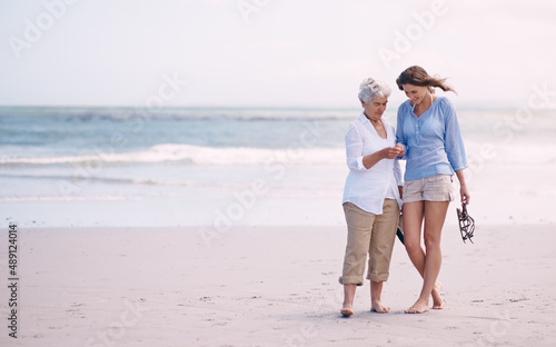Discoveries with my daughter. Shot of a senior mother and her adult daughter exploring the beach.