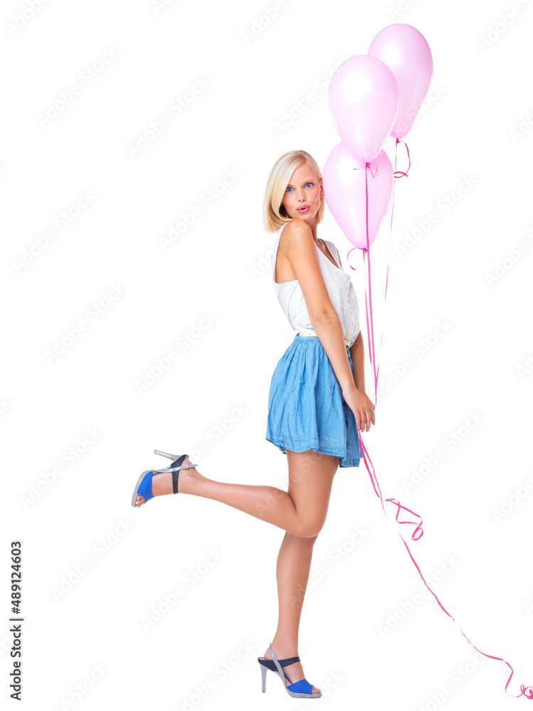 Sassy and cute. Flirtatious young woman popping her foot and holding a bunch of pink balloons. Sassy and cute. Flirtatious young woman popping her foot and holding a bunch of pink balloons.