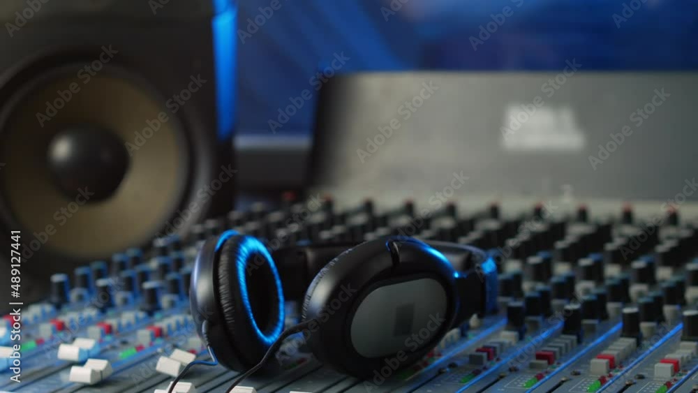 Headphones on a mixing desk in an audio recording studio Headphones on a mixing desk in an audio recording studio