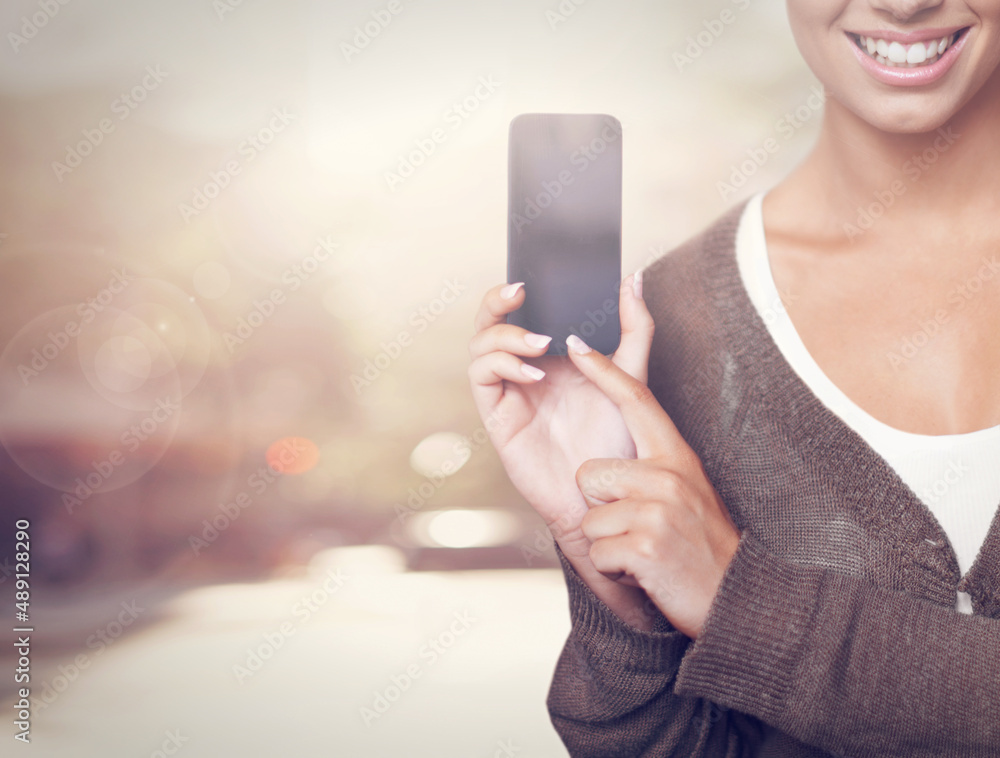 Smartphones for smart people. A cropped shot of a young woman holding and pointing to her smartphone. Smartphones for smart people. A cropped shot of a young woman holding and pointing to her smartphone.