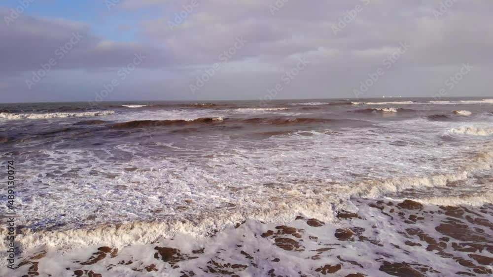 Aerial Low Flying Over Rough Sea Waves Along Katwijk aan Zee Beach Coastline In South Holland