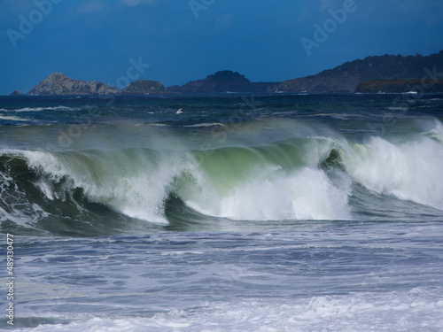 Breaking wave over sandy beach at Bodega bay California.