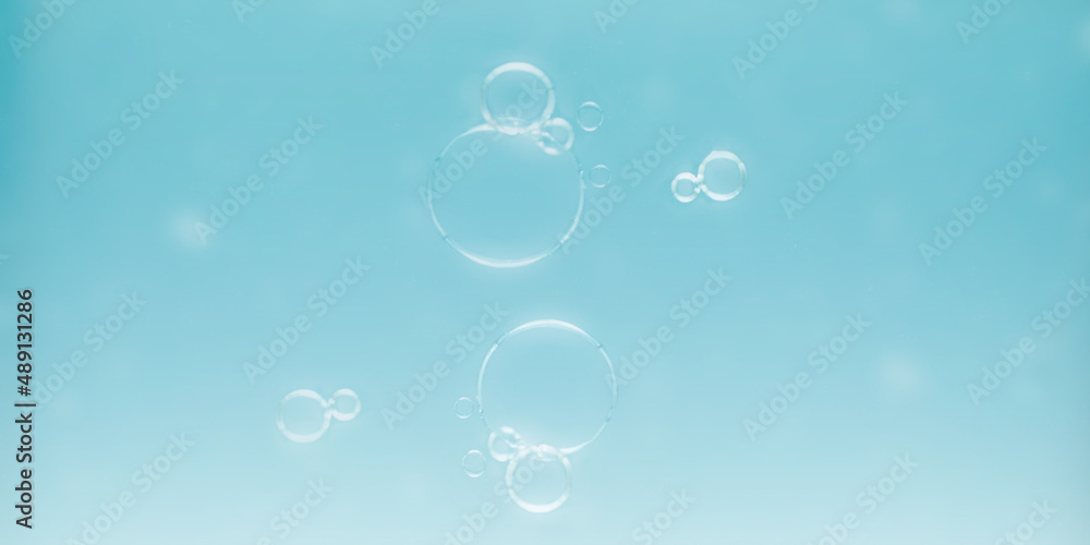 Soap bubbles with light blue background for text and advertising.