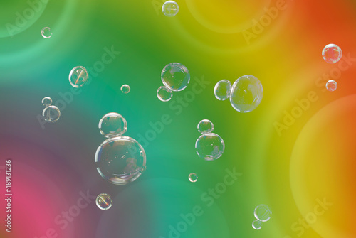 Soap bubbles with rainbow colored background for text and advertising.